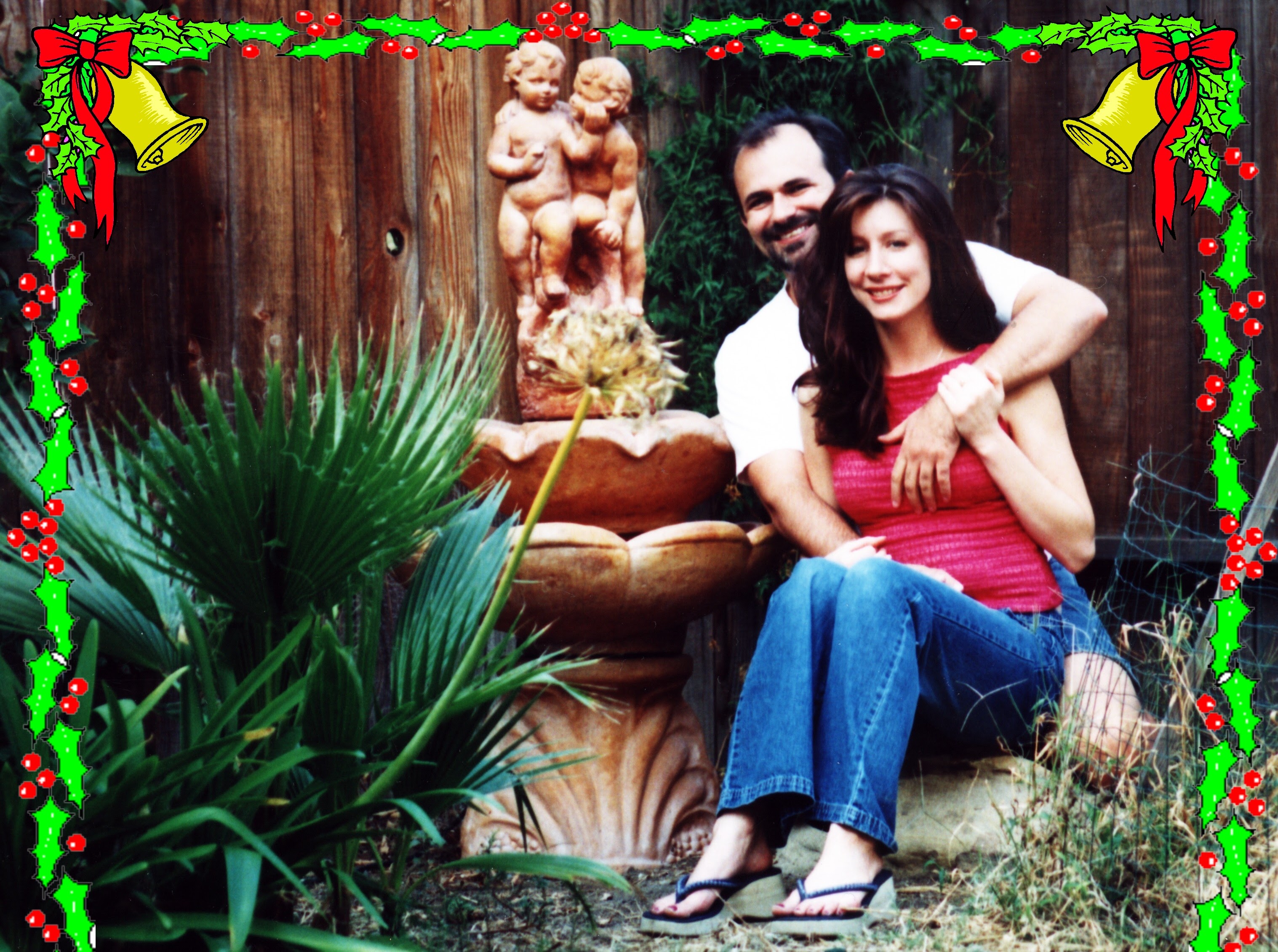 Themio and Christian by their garden fountain at Christmas